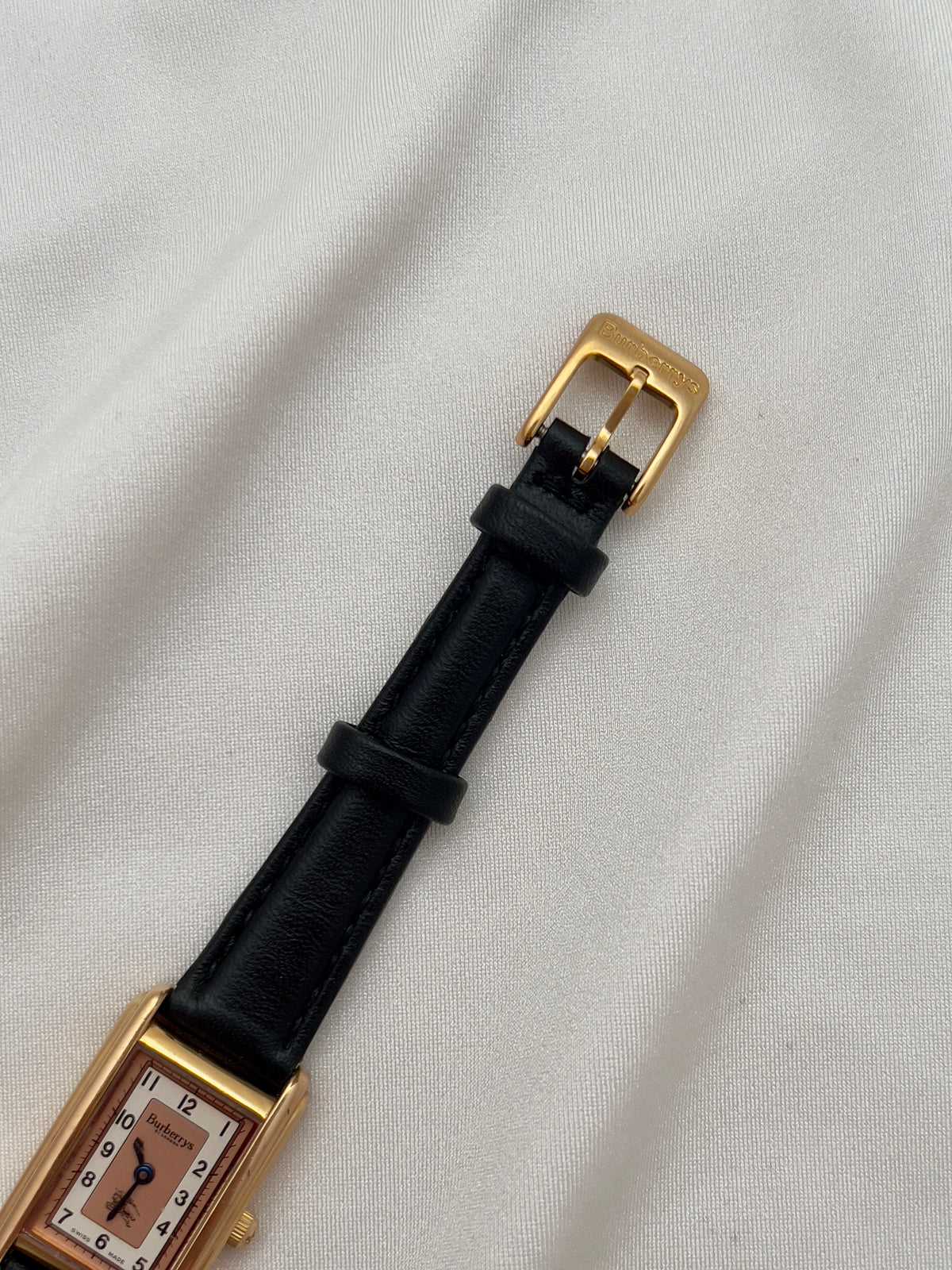 Burberrys Salmon Dial Gold Tank Women’s Watch; black leather strap with burberrys buckle. Product photograph 9 of 15.