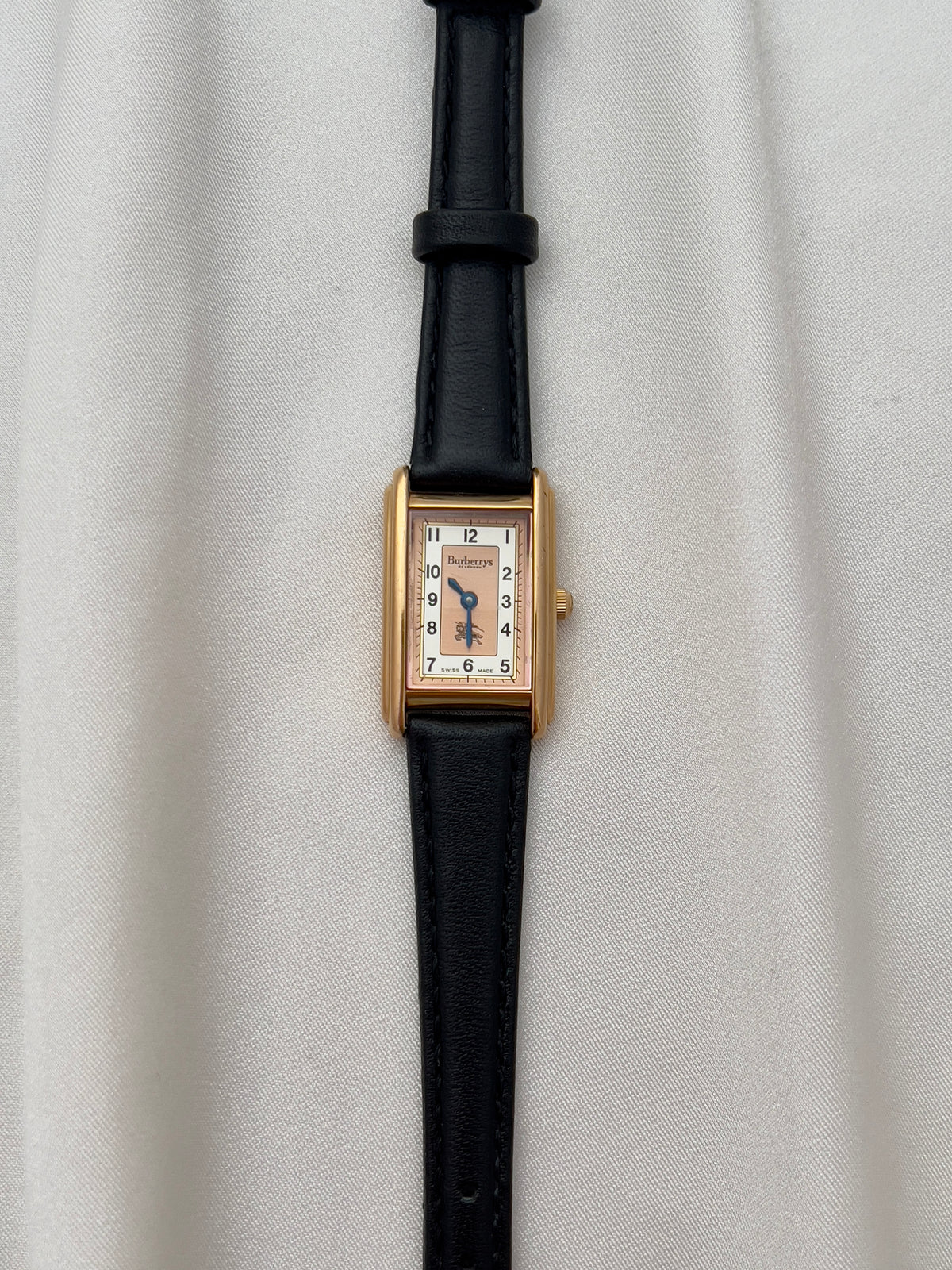 Burberrys Salmon Dial Gold Tank Women’s Watch; black leather strap with burberrys buckle. Product photograph 13 of 15.