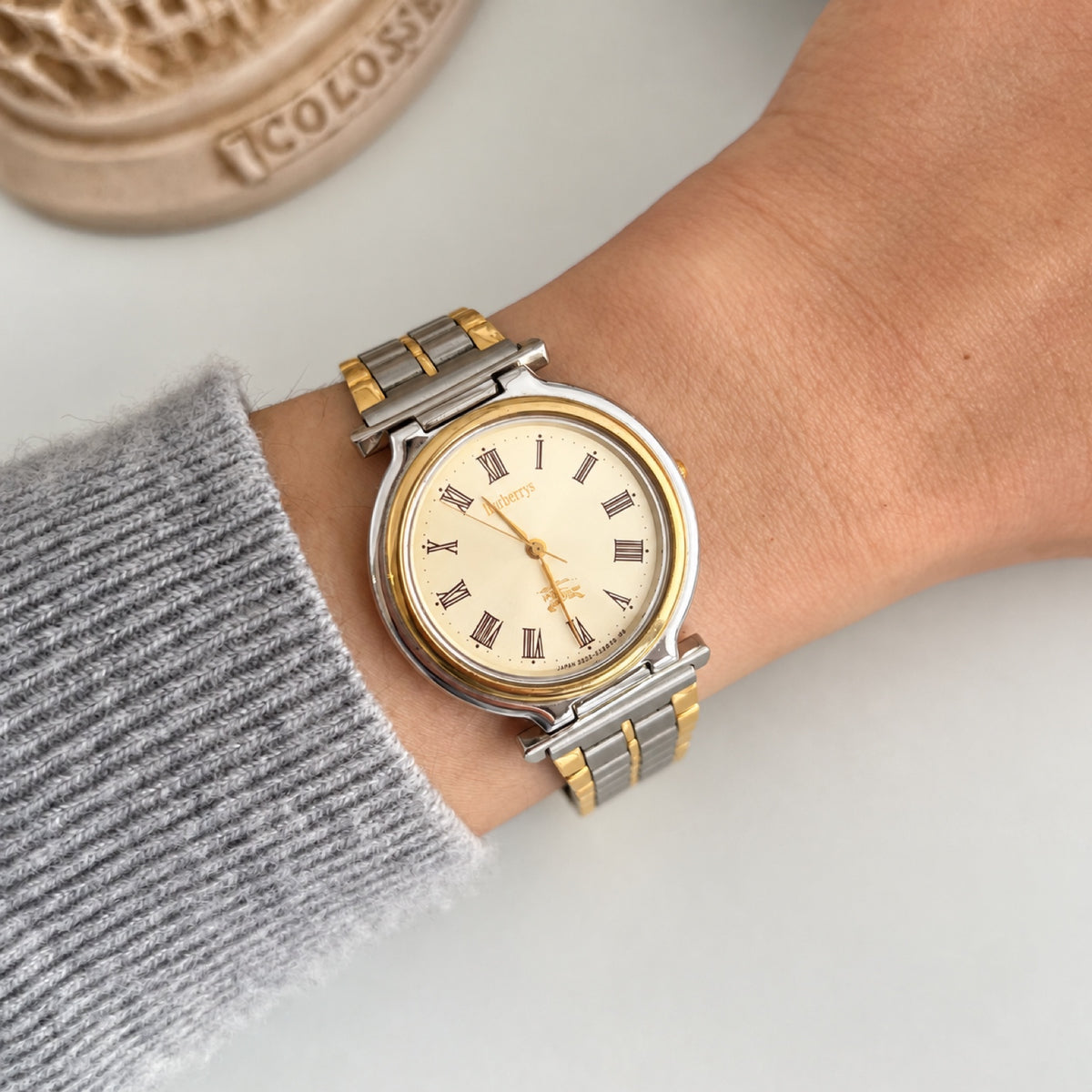 Burberry cream Roman dial watch with a two tone bracelet, pictured on a 15 cm wrist.