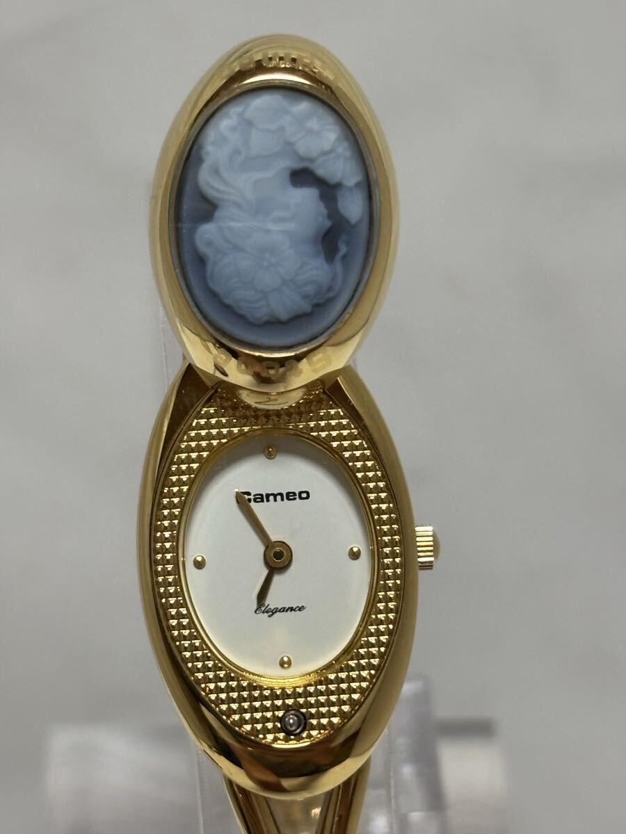 Open view of the Cameo Elegance stone cameo swivel watch revealing the oval white dial and gold-tone bracelet
