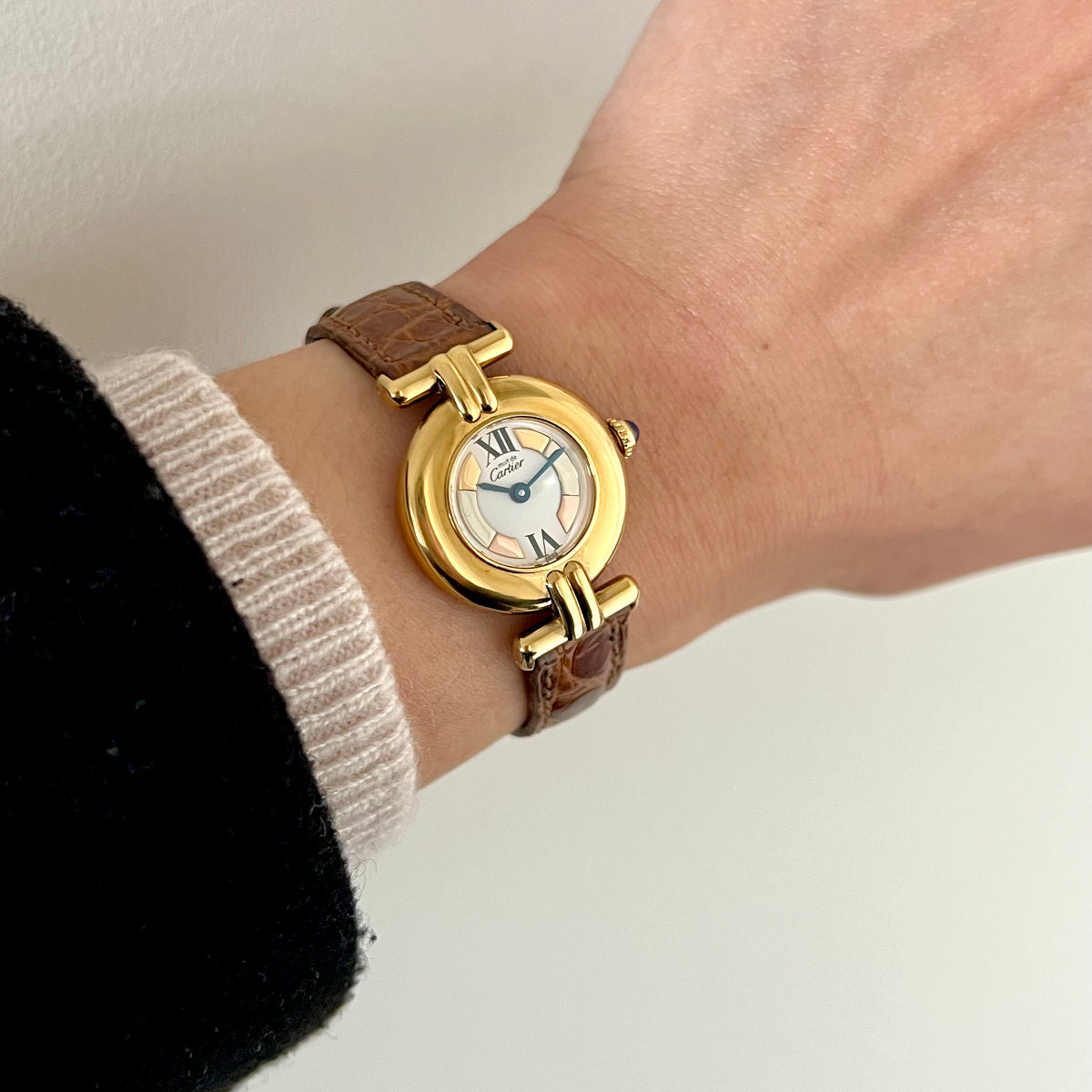 Must de Cartier Colisee women’s watch on a brown leather strap worn on the wrist