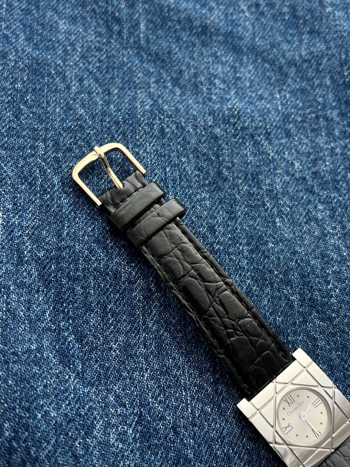 Gold tone buckle and black textured leather strap on the Christian Dior Cannage women’s watch
