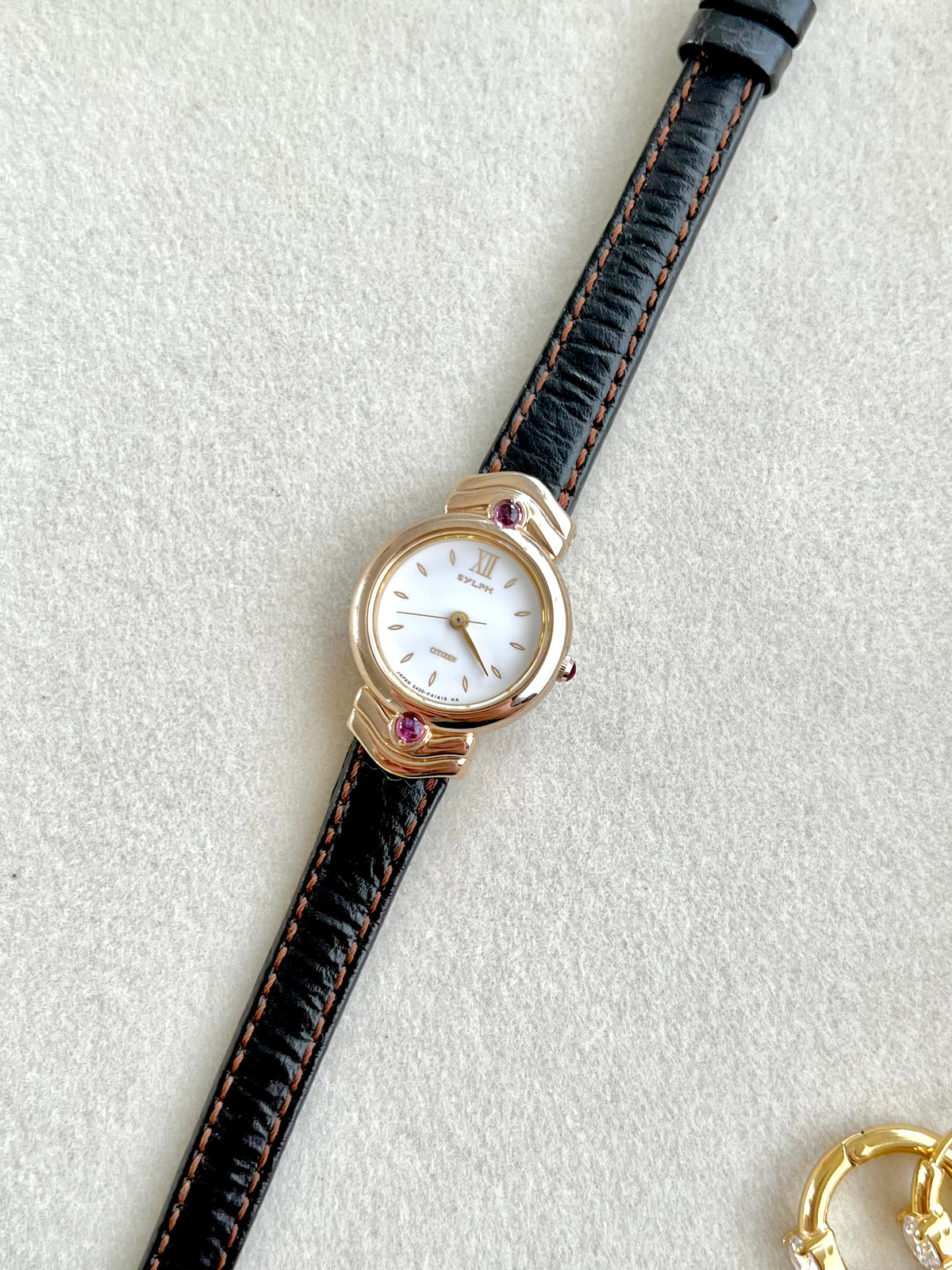 Citizen Gold Toned Women's Watch with Purple Stone, wrist shot of a vintage women's watch at Gilded Hour.