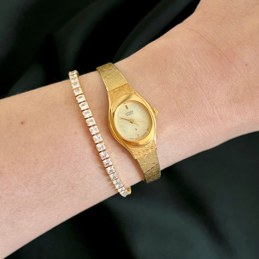 Citizen CQ 5930-S25350 champagne dial gold-tone watch worn on the wrist