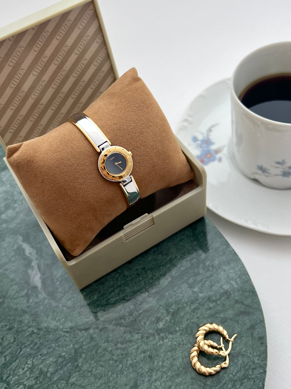 Close-up of the Citizen Chere black dial and engraved gold bezel.