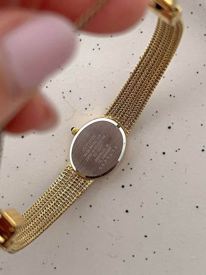 Close-up of the Citizen champagne dial with polished gold-tone markers and hands.