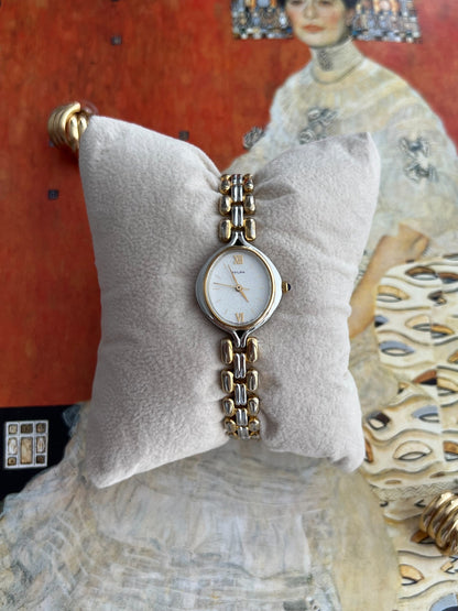 Citizen Sylph women’s watch with a frosted silver oval dial, gold Roman XII and VI, and rounded two tone bracelet