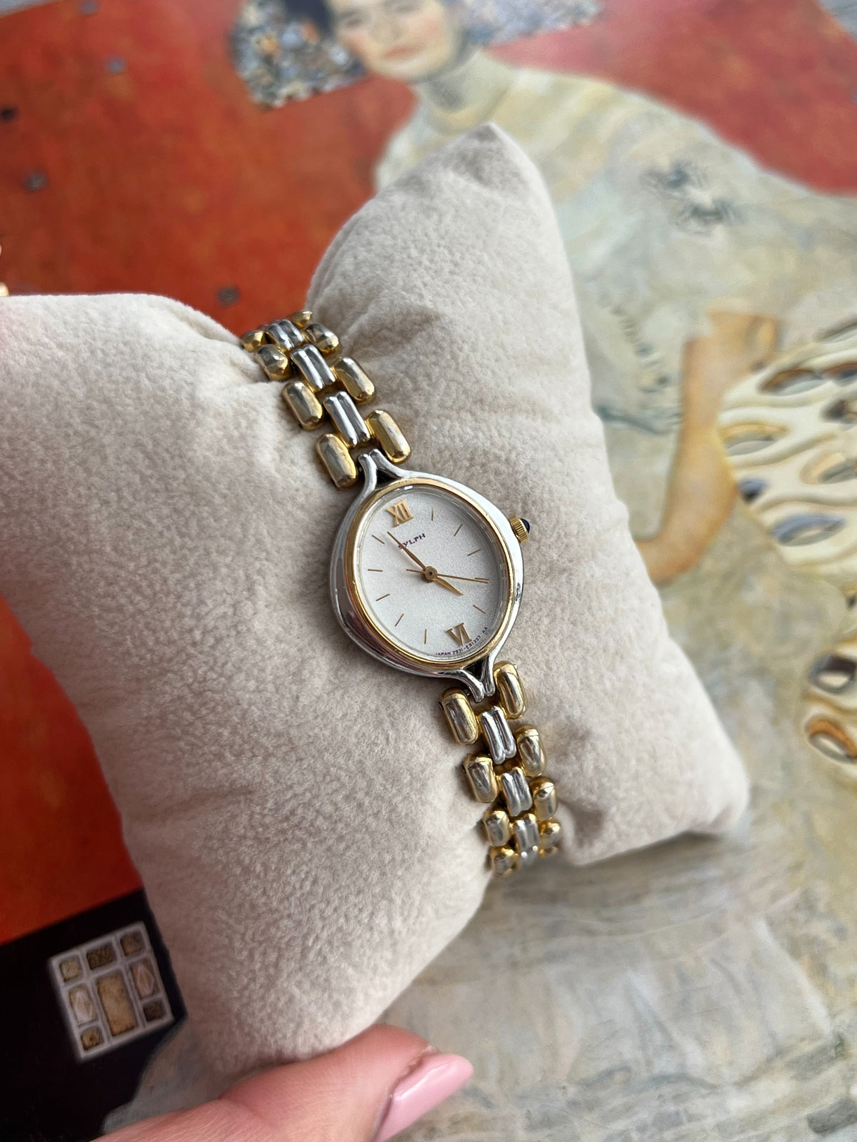 Angled view of the Citizen Sylph oval dial and rounded gold outer links with silver tone centre links