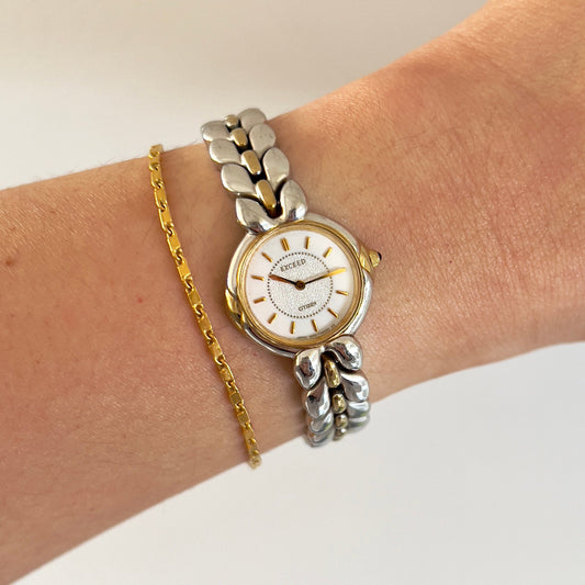 Citizen Two Tone Woman's Watch with Leaf Bracelet, Diamond Dust Dial & Blue Crown Stone — watch face and case shown from the front.