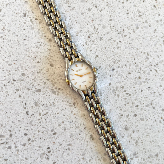Citizen Womans Watch with a Volcanic Patterned Case & Green Crown Stone — watch face and case shown from the front.