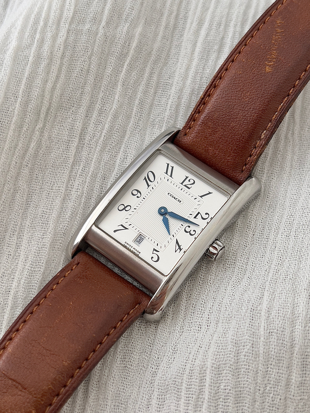 Caseback detail of the Coach classic rectangular watch.