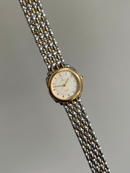 Angled view of the Cyma Sealord gold tone bezel, shaped silver tone case and cream dial.