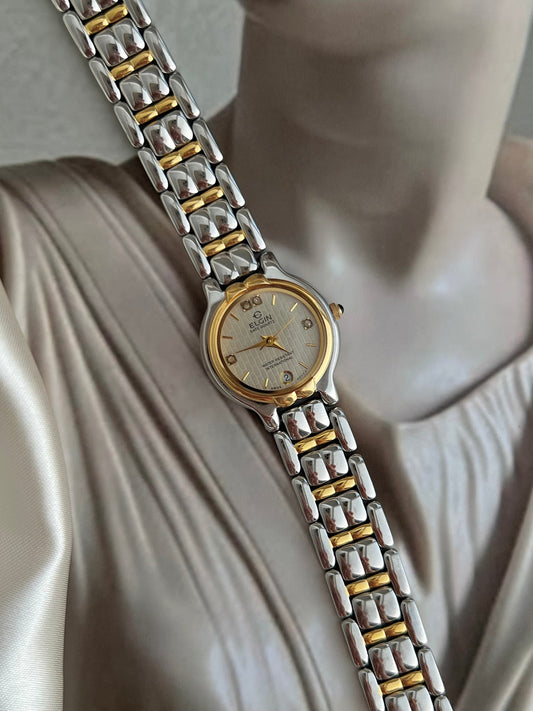 Elgin Two Tone Woman’s Watch with Textured Dial — the watch displayed on a mannequin with its two-tone bracelet.