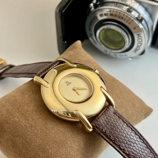 Fendi 400G watch with champagne dial, polished gold tone case and original brown textured strap.