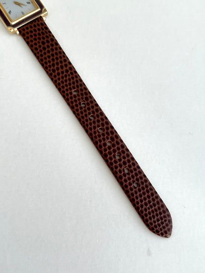 Seiko Brown Frame Roman Dial Leather Strap Watch: brown strap tip.