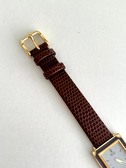 Seiko Brown Frame Roman Dial Leather Strap Watch: gold tone buckle.