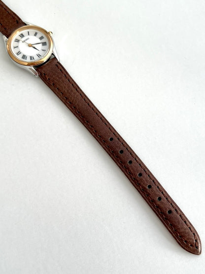Seiko Exceline brown leather strap showing dark stitching, adjustment holes and rounded strap tip