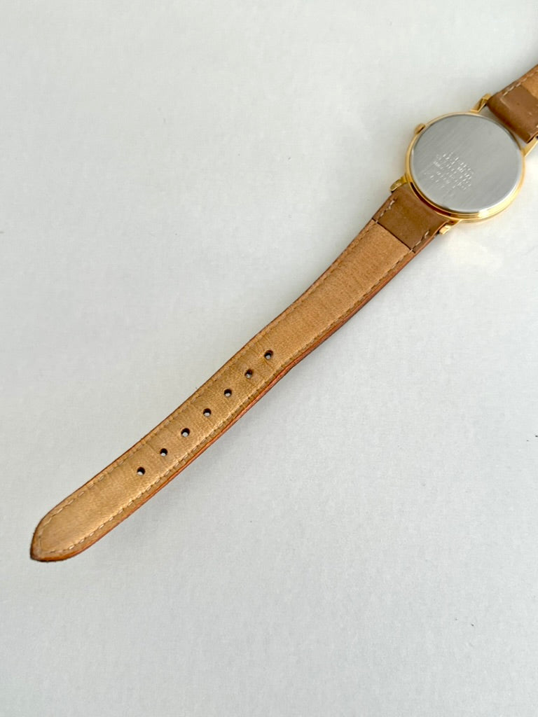 Rear view of the Seiko caseback and tan leather strap