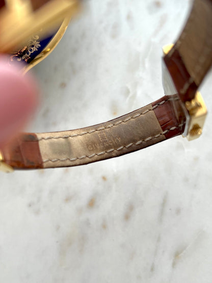 Underside of the brown Givenchy leather strap showing its signature and existing wear