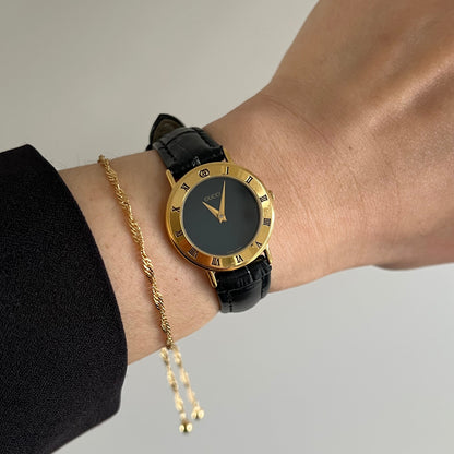 Gucci 3000.2 black dial Women’s watch with gold Roman numeral bezel