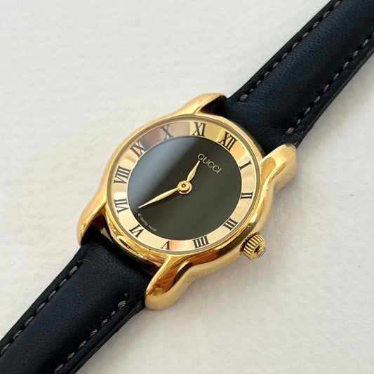 Gucci black dish dial ladies watch, front view.