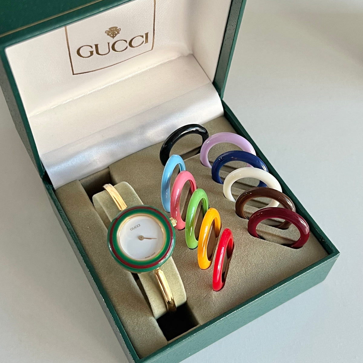 Gucci 11/12 gold tone watch with its original interchangeable coloured bezel set