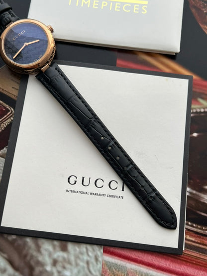 Gucci Diamantissima women’s watch showing the black leather strap texture, stitching and adjustment holes.