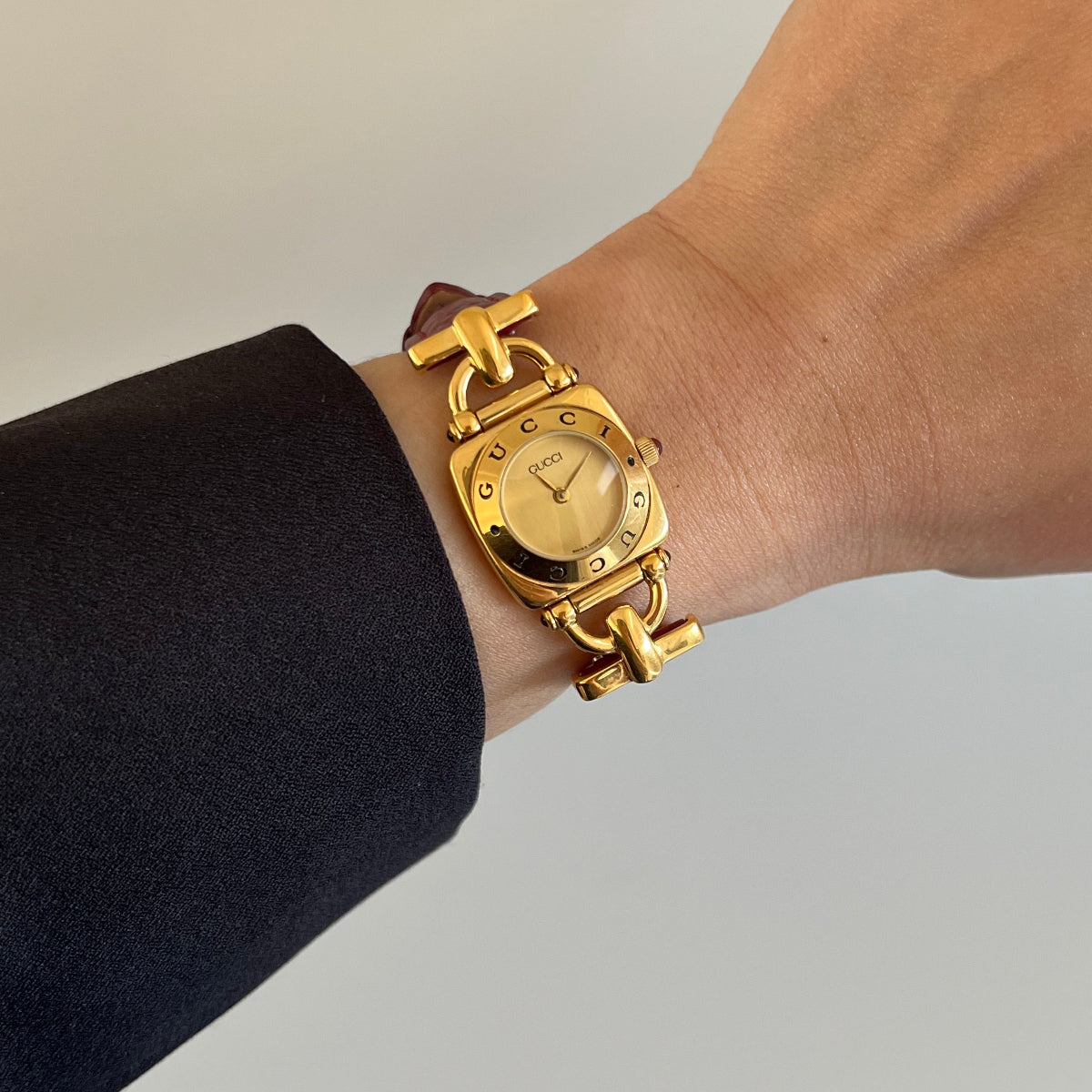 Gold tone Gucci Horsebit women’s watch photographed on the wrist