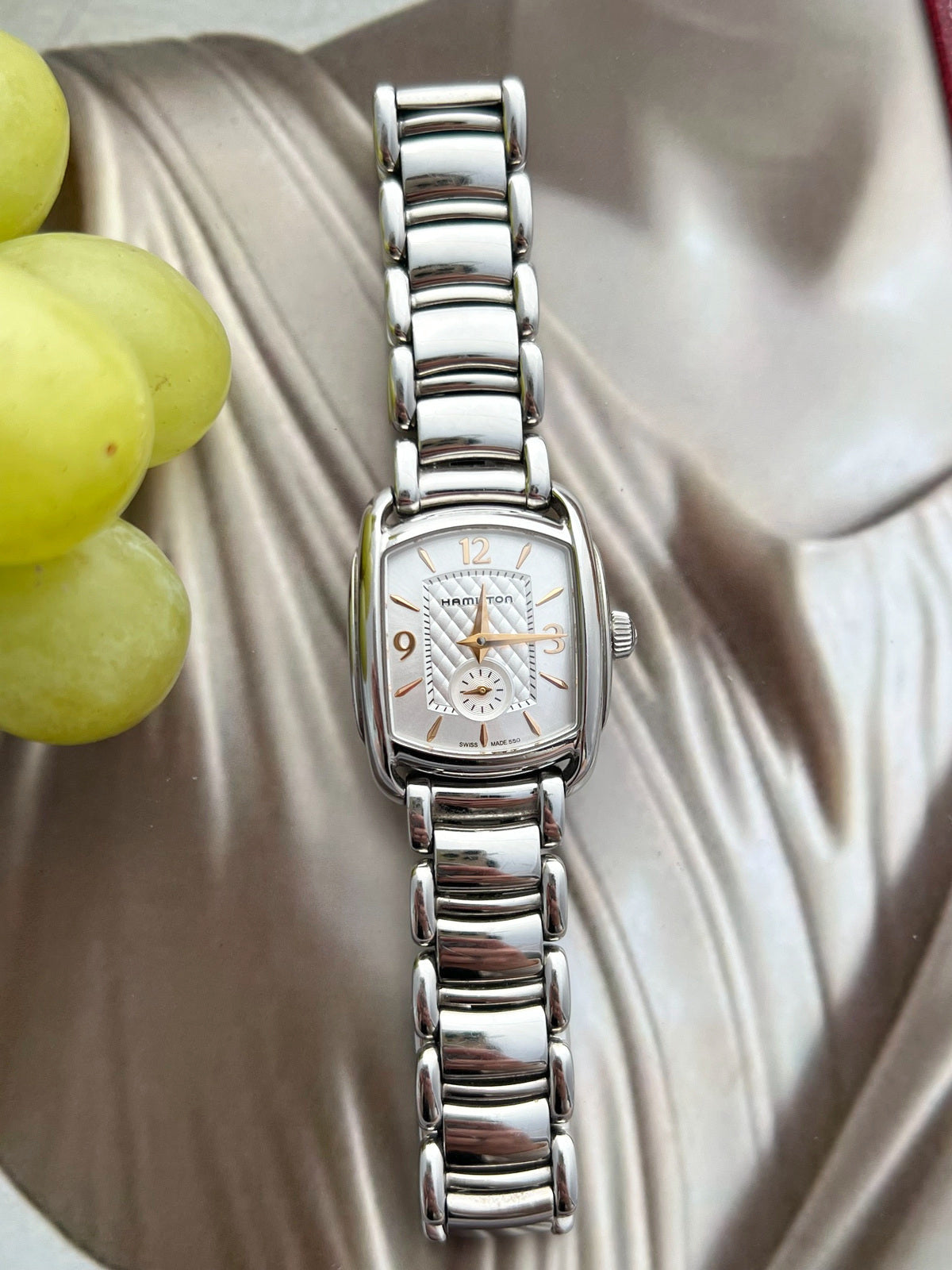 Front view of the Hamilton Bagley showing its silver quilted centre, rose gold tone Arabic numerals and small seconds dial at six.