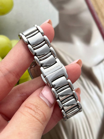Close view of the Hamilton signed folding clasp and broad polished links on the Bagley stainless steel bracelet.
