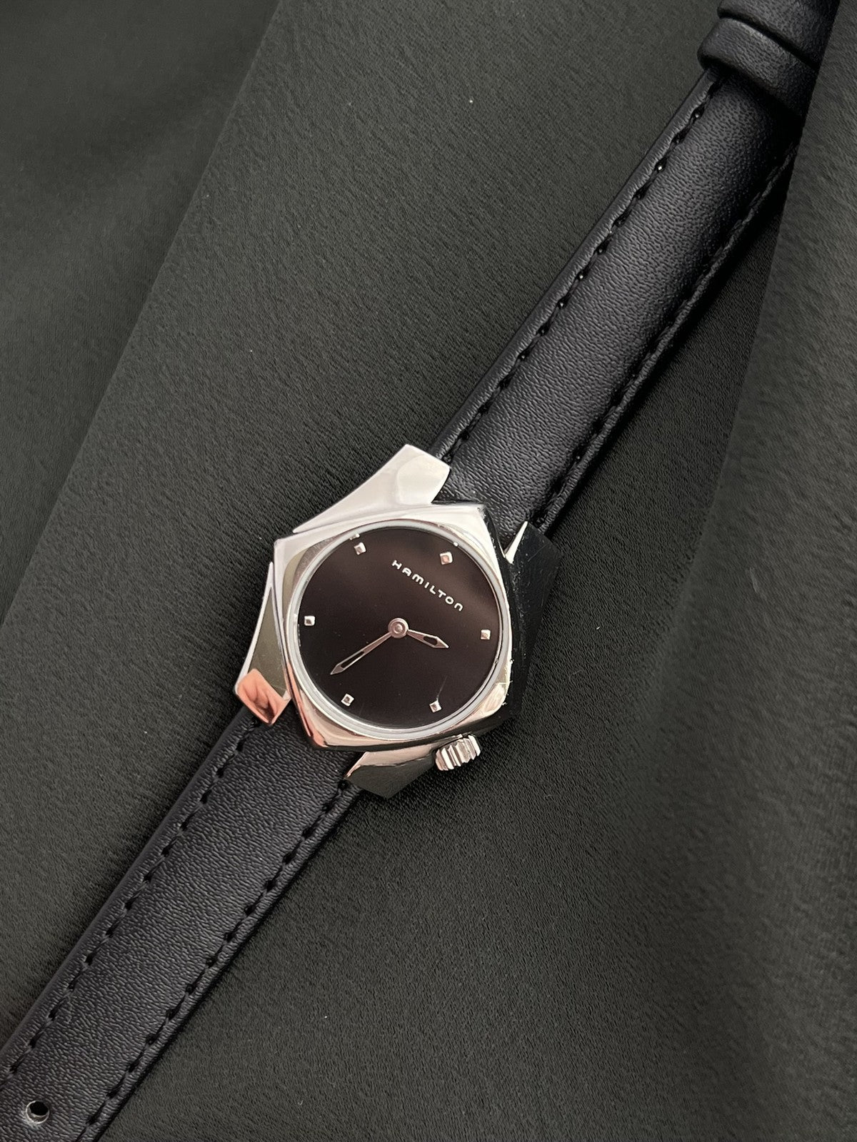 Angled view of the Hamilton Stardom 6357 black dial and sculptural stainless steel case