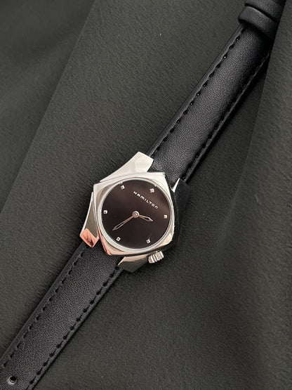 Angled view of the Hamilton Stardom 6357 black dial and sculptural stainless steel case