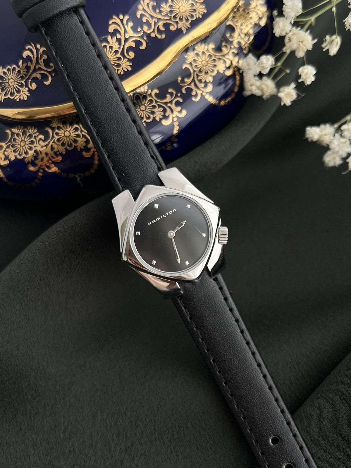 Hamilton Stardom 6357 black dial silver-tone angular stainless steel watch on a black leather strap, front view