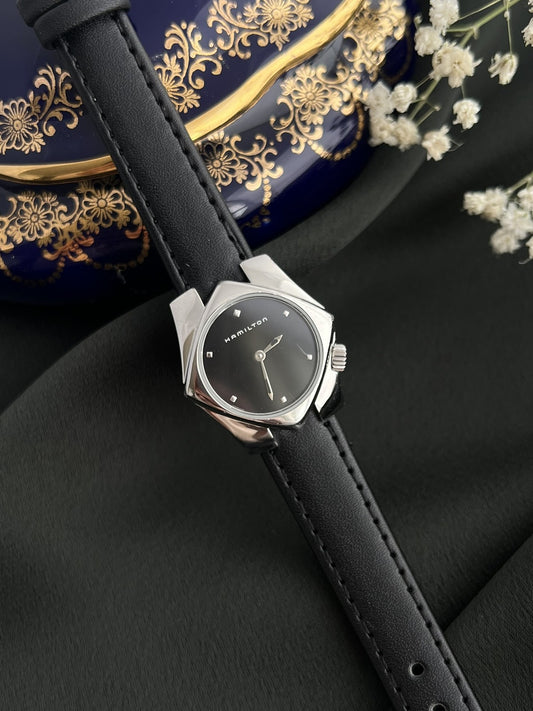 Hamilton Stardom 6357 black dial silver-tone angular stainless steel watch on a black leather strap, front view