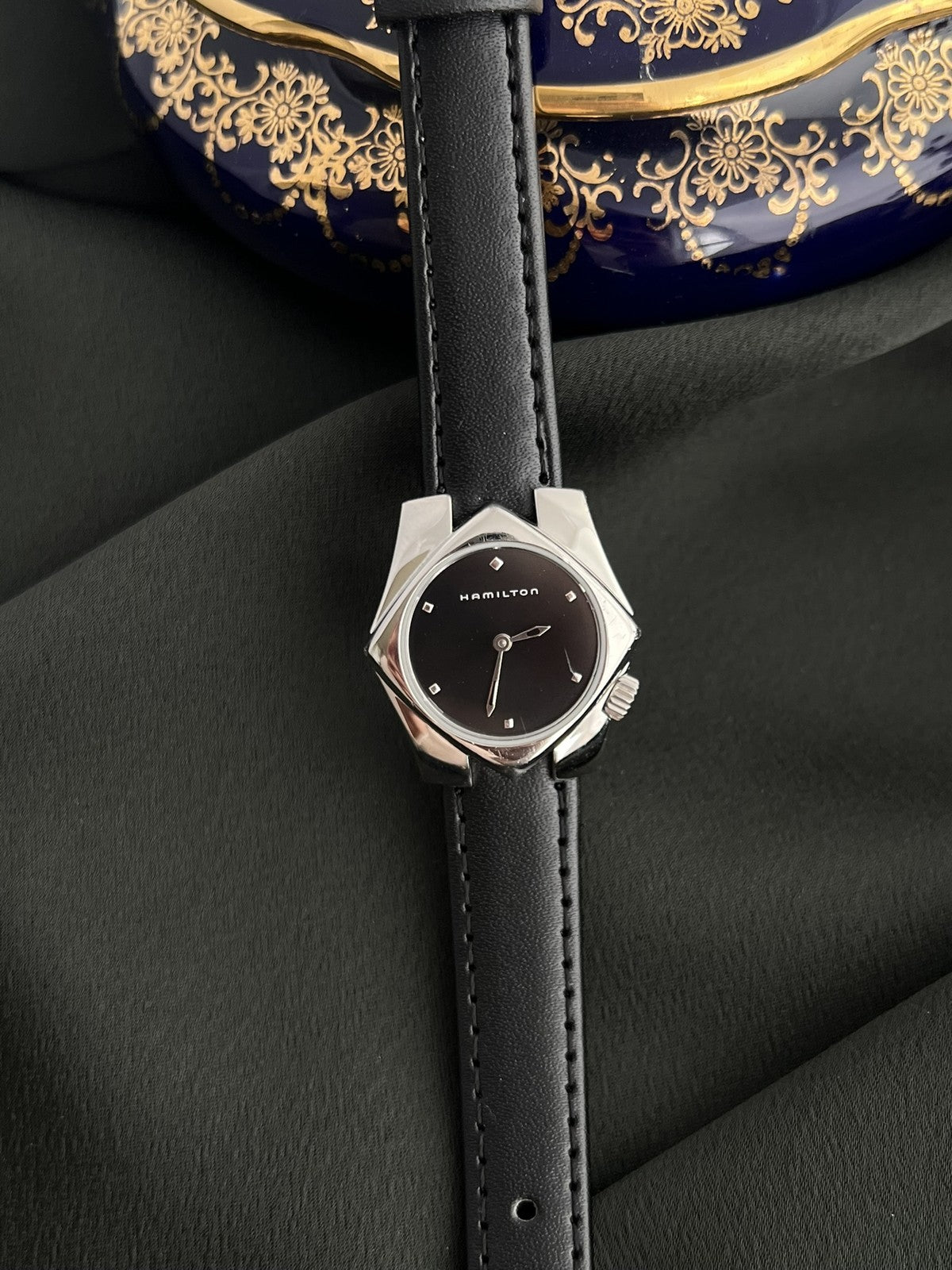 Front view of the Hamilton Stardom 6357 with black dial, faceted hour markers and sculptural silver-tone case