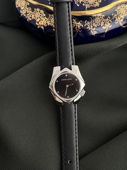 Front view of the Hamilton Stardom 6357 with black dial, faceted hour markers and sculptural silver-tone case