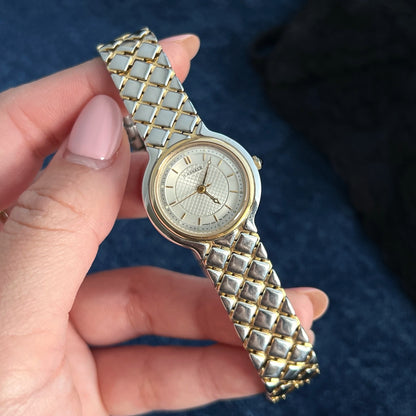 Close view of the Lassale by Seiko lattice dial, gold tone hour markers and two tone bracelet