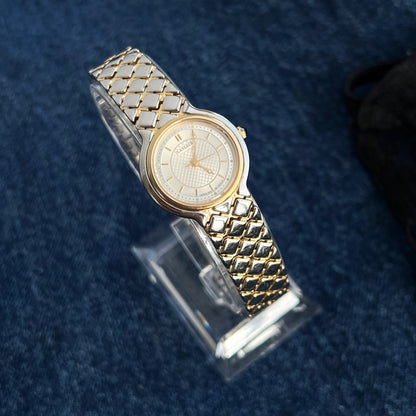 Three quarter view of the Lassale by Seiko women’s watch with a gold tone bezel and diamond link bracelet