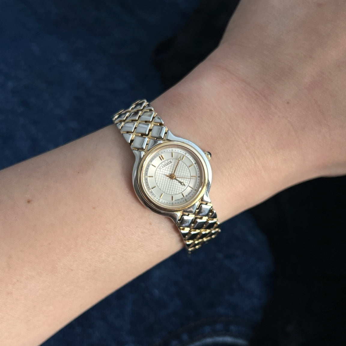 Lassale by Seiko two tone women’s watch with a lattice dial and diamond link bracelet pictured on a 15 cm wrist
