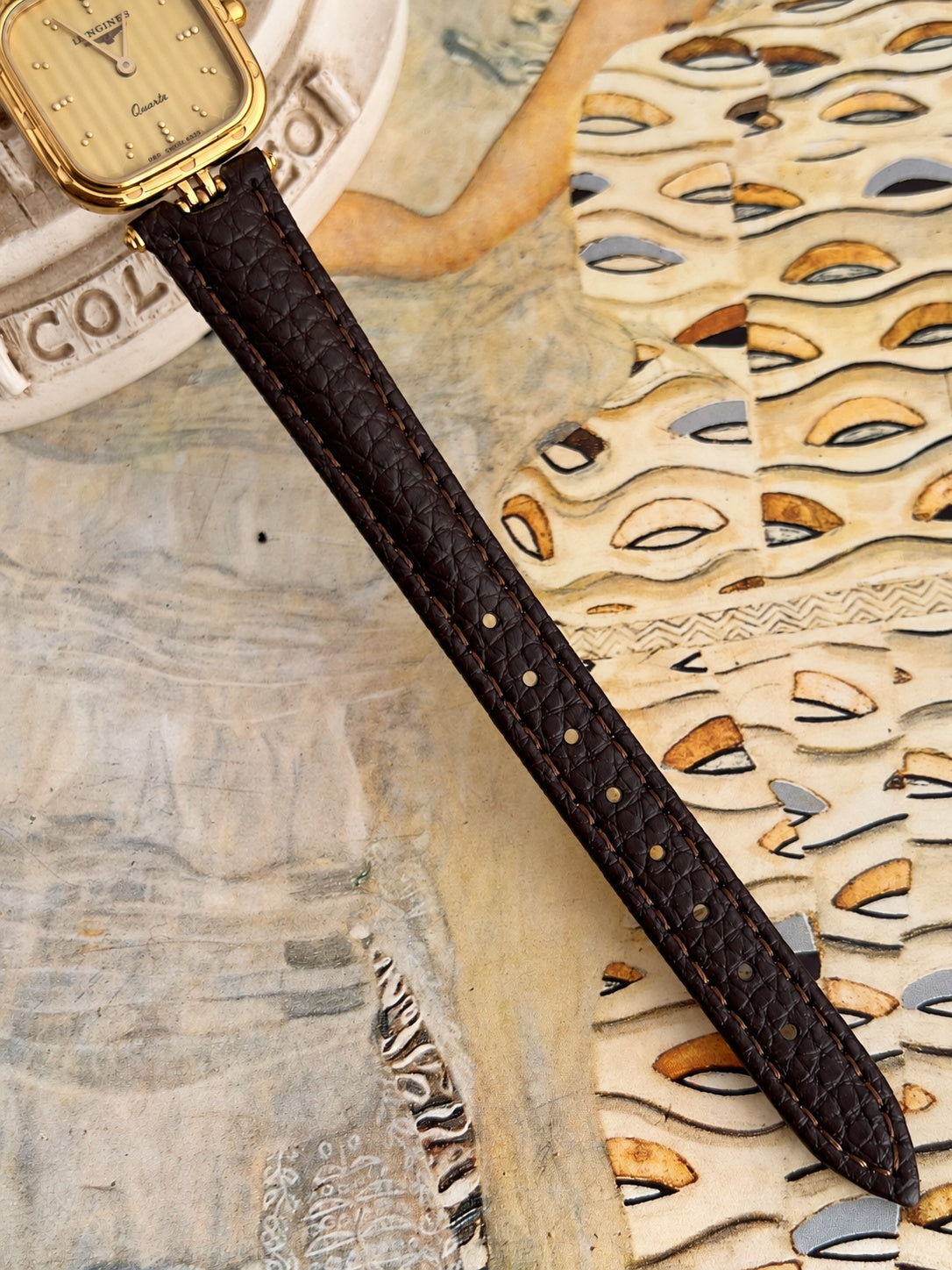 New aftermarket dark brown patterned leather strap with warm stitching and adjustment holes fitted to the Longines watch.