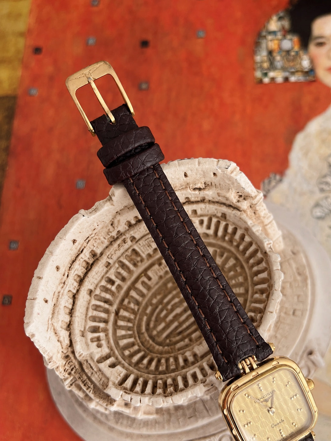 Original Longines signed gold tone pin buckle and new dark brown leather strap with two keepers.