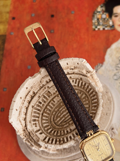 Original Longines signed gold tone pin buckle and new dark brown leather strap with two keepers.