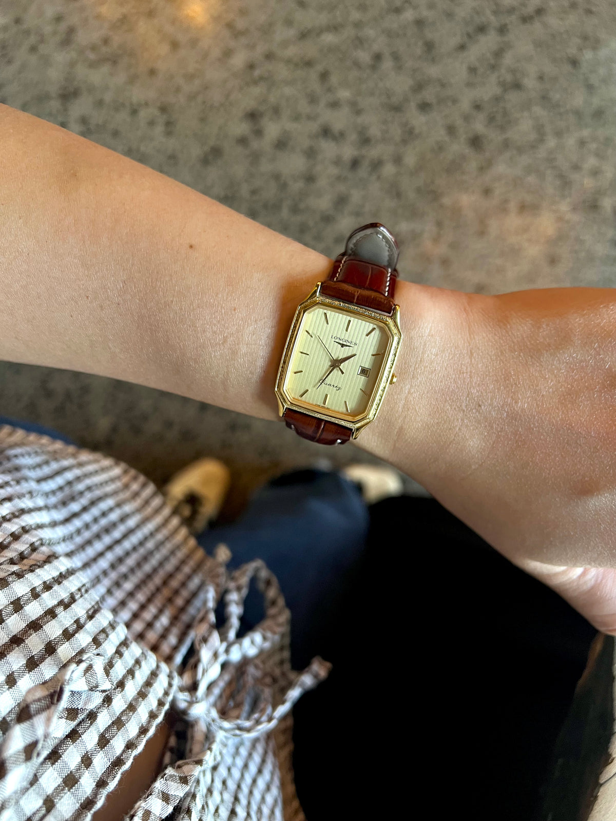 Longines Champagne Textured Bezel Women’s Watch — Worn on the wrist with a brown leather strap