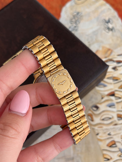 Longines Conquest gold tone bracelet and signed winged hourglass folding clasp, showing the original texture and surface wear.