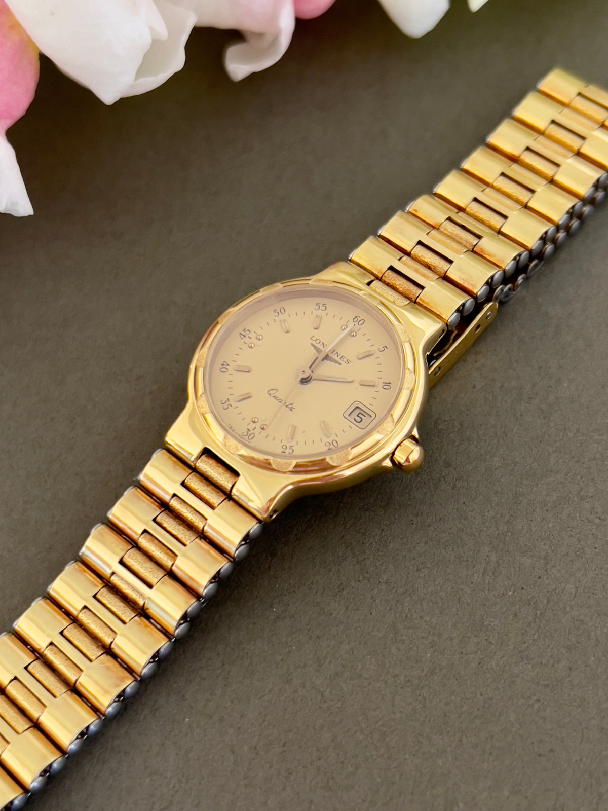 Longines Conquest Gold Women’s Watch with Scalloped Bezel — angled view of scalloped bezel and dial.
