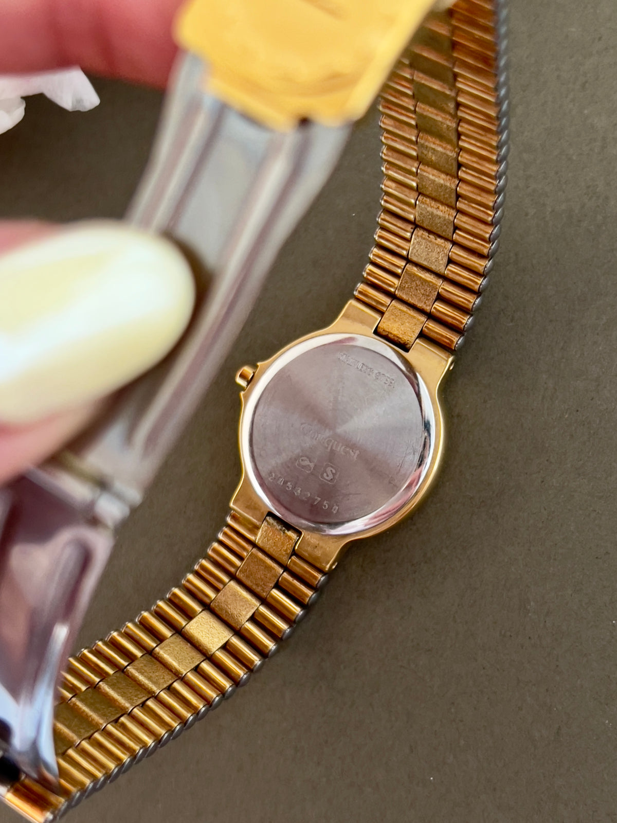 Longines Conquest Gold Women’s Watch with Scalloped Bezel — caseback markings and bracelet underside.