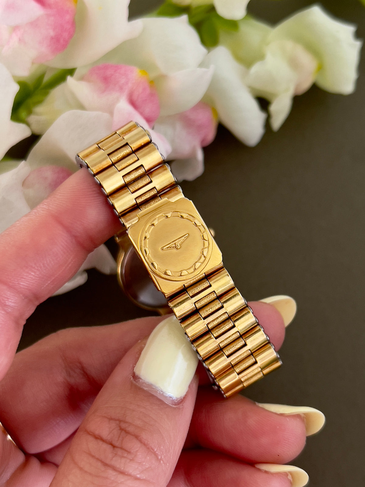 Longines Conquest Gold Women’s Watch with Scalloped Bezel — bracelet clasp held in the hand.