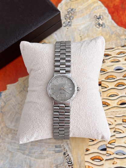 Front view of the Longines Conquest silver tone bracelet watch with silver grey dial and date window.