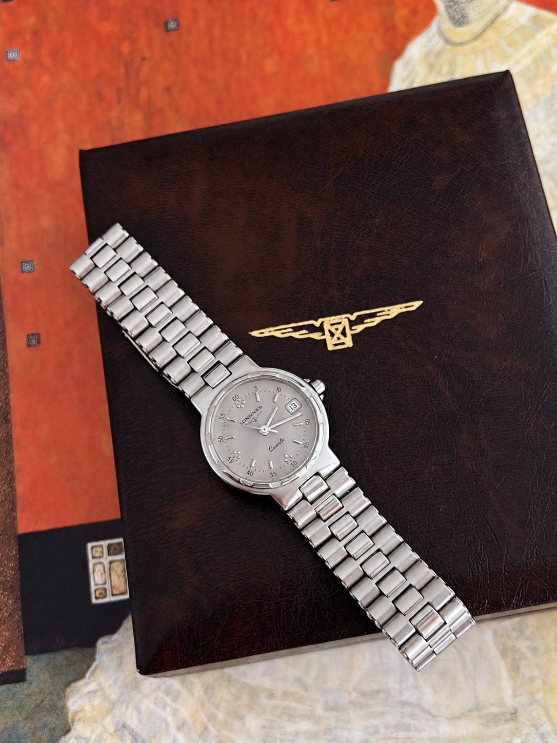 Longines Conquest silver grey dial with numbered minute track, silver baton markers, three hands and framed date.