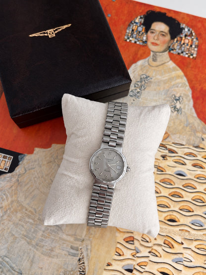 Full view of the Longines Conquest silver grey dial bracelet watch beside a Longines box.
